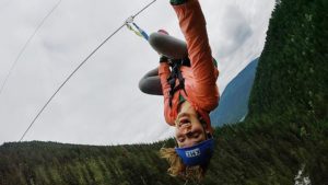A girl upside down on Kokanee Mountain Zipline